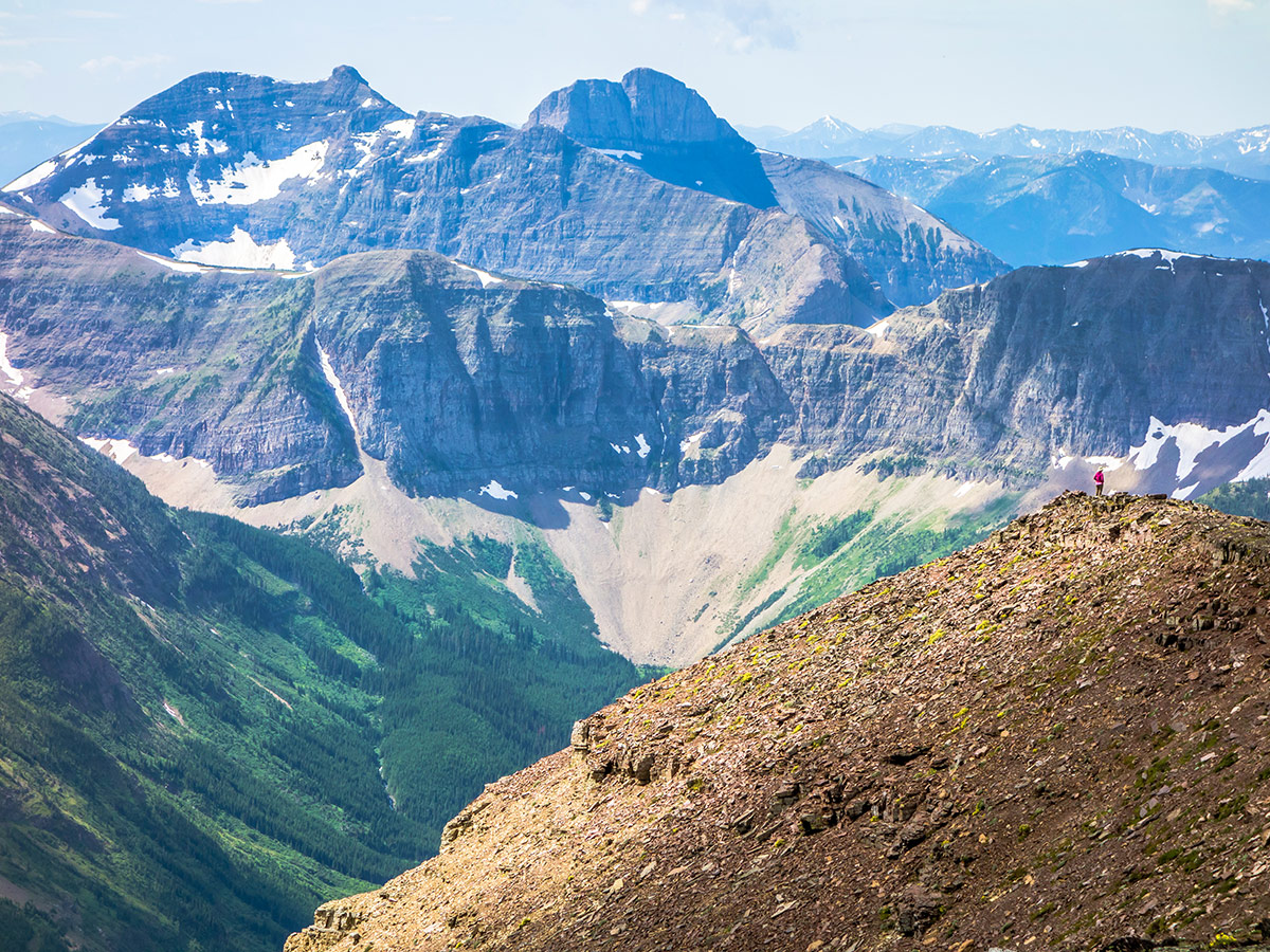 Dwarfed by the scenery on Syncline Mountain on Mount Coulthard scramble in Castle Provincial Park, Alberta