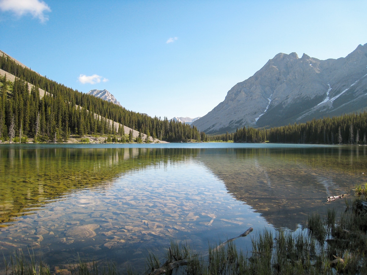 Walking along Elbow Lake on Tombstone Lakes backpacking trail near Kananaskis, the Canadian Rockies