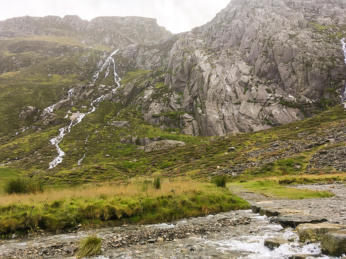 Stepping stones over the stream running into the lake on Cwm Idwal walk in Snowdonia, Wales