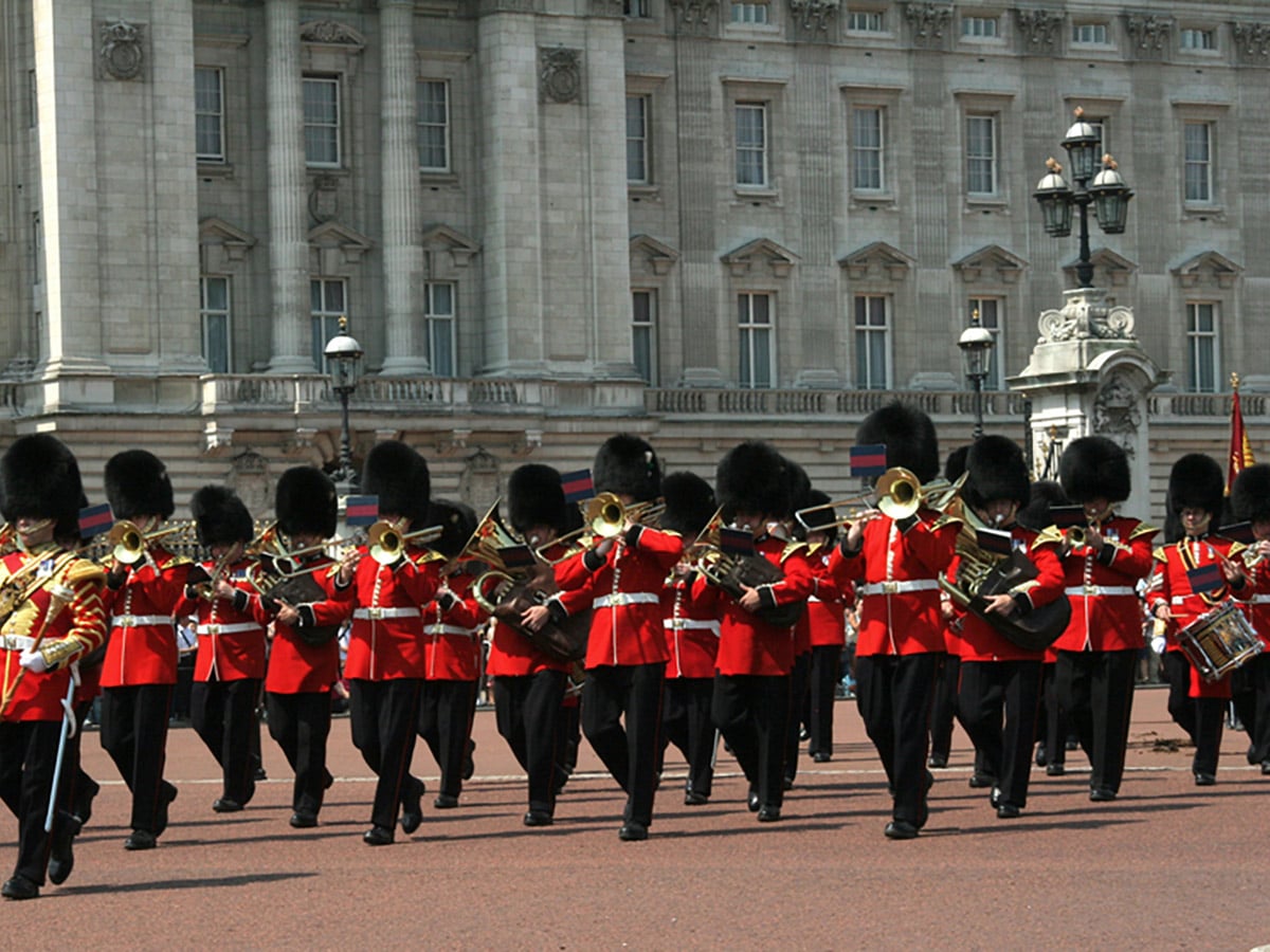 Guards Marching outside of Buckingham Palace on St. James, Green, Hyde and Kensington parks walking tour in London, England