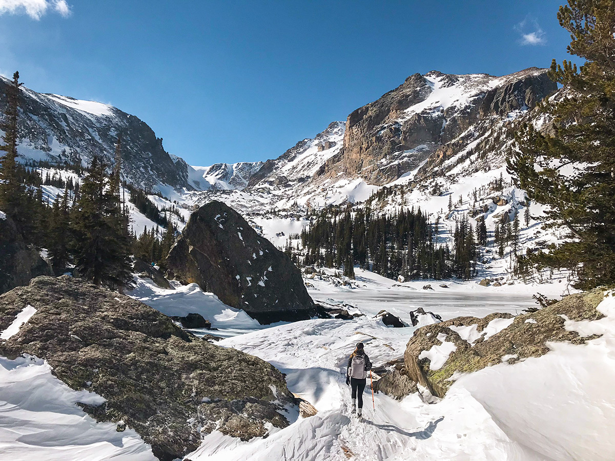 Hiker approaching the lake on Lake Haiyaha hike in Rocky Mountain National Park, Colorado