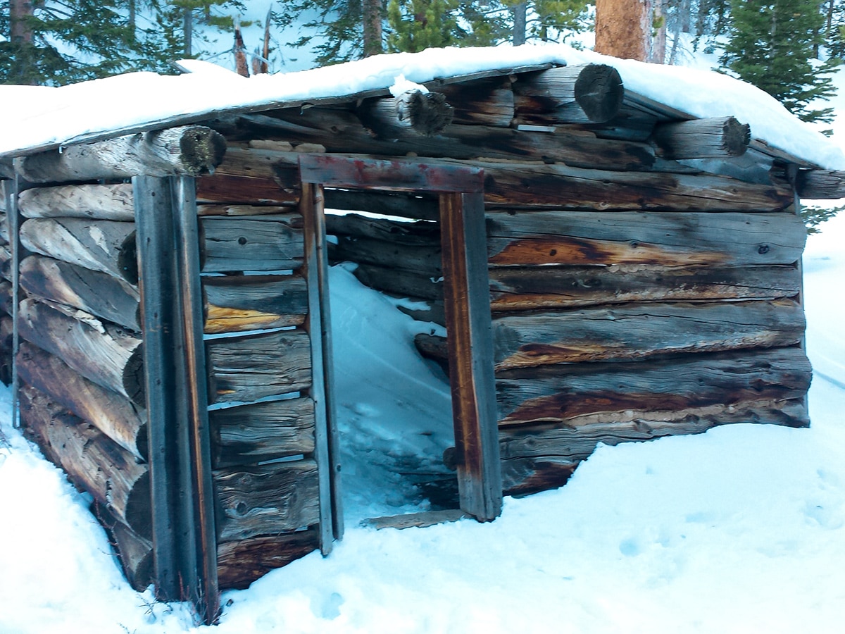 Log houses on St. Mary's Glacier hike in Denver are full of snow