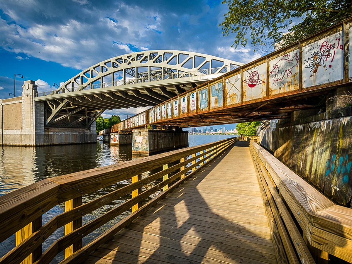 Boardwalk under a rail bridge under the Boston University on Charles River city walk in Boston, Massachusetts