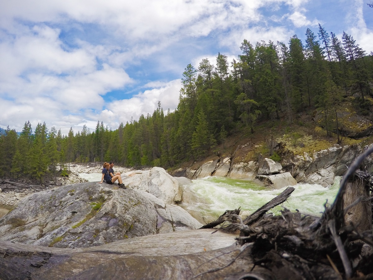 Hikers resting near a creek on Fry Creek Canyon hike in West Kootenays