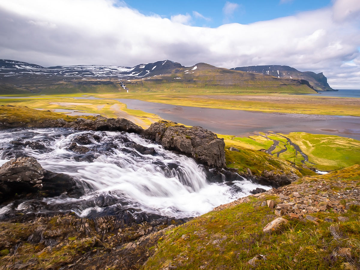 Waterfall and a large river on Iceland’s Hornstrandir Nature Reserve trek