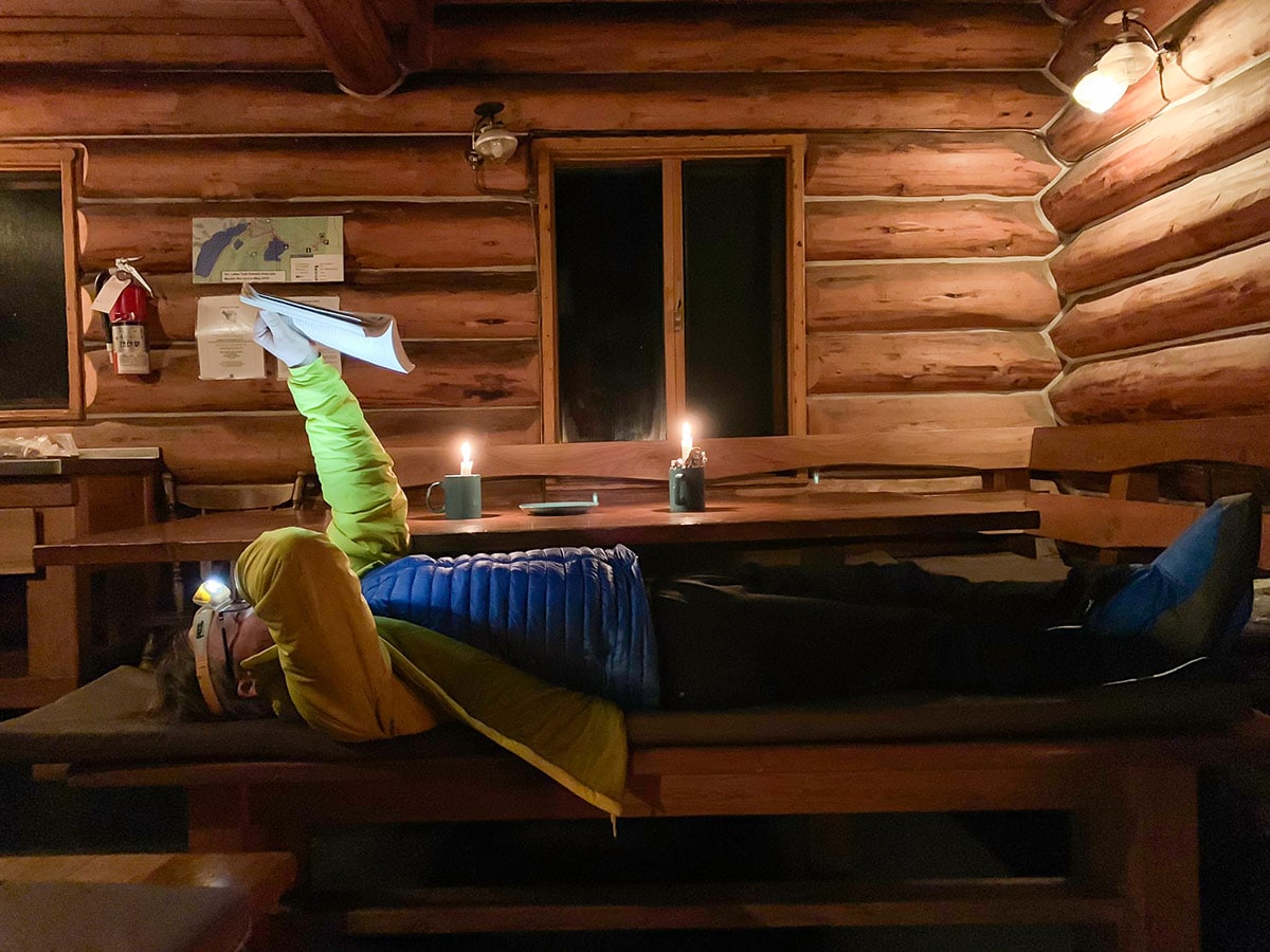 Reading at Elk Lakes Cabin on Elk Lakes Backcountry Skiing Adventure