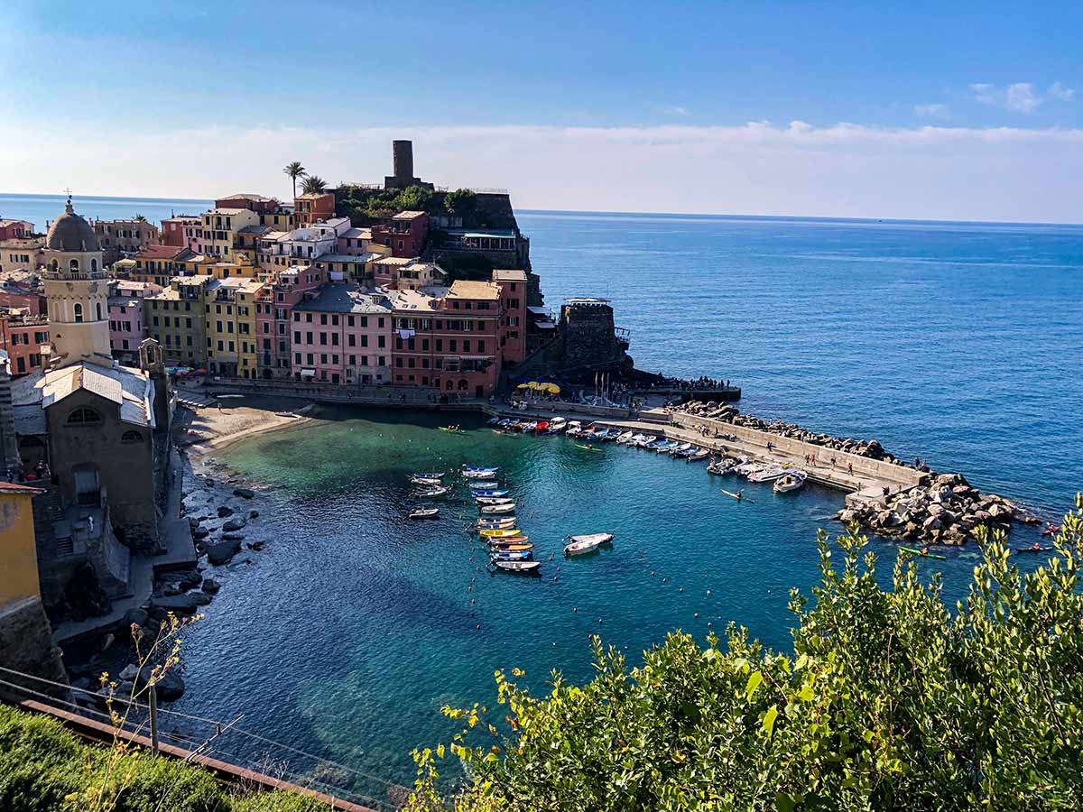 Vernazza and boats in the cove on Cinque Terre hike in Liguria, Italy