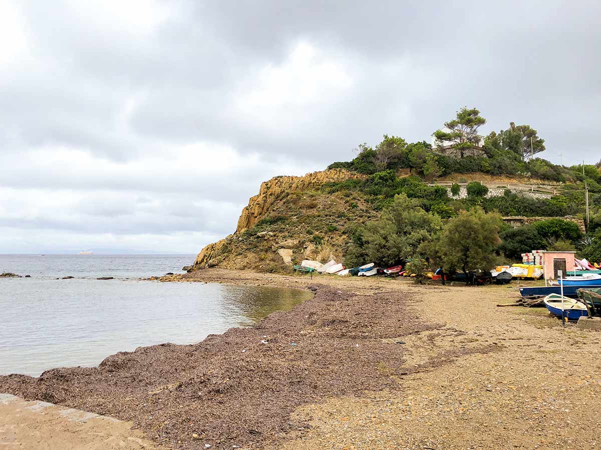 Boats near the small beach in Elba Island on Enfola Peninsula Hike in Tuscany