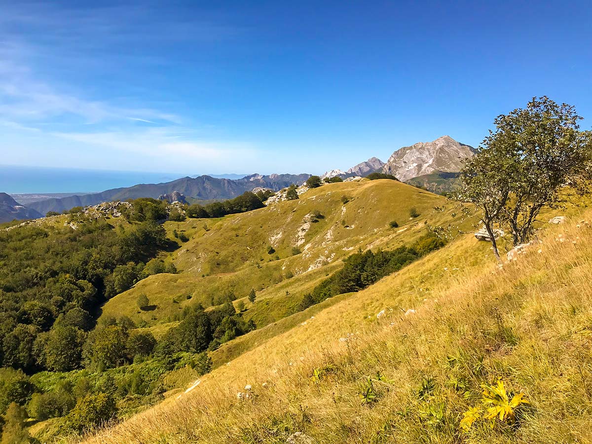 Beautiful mountains and sea in the distance on Monte Croce from Palagnana Hike in Tuscany