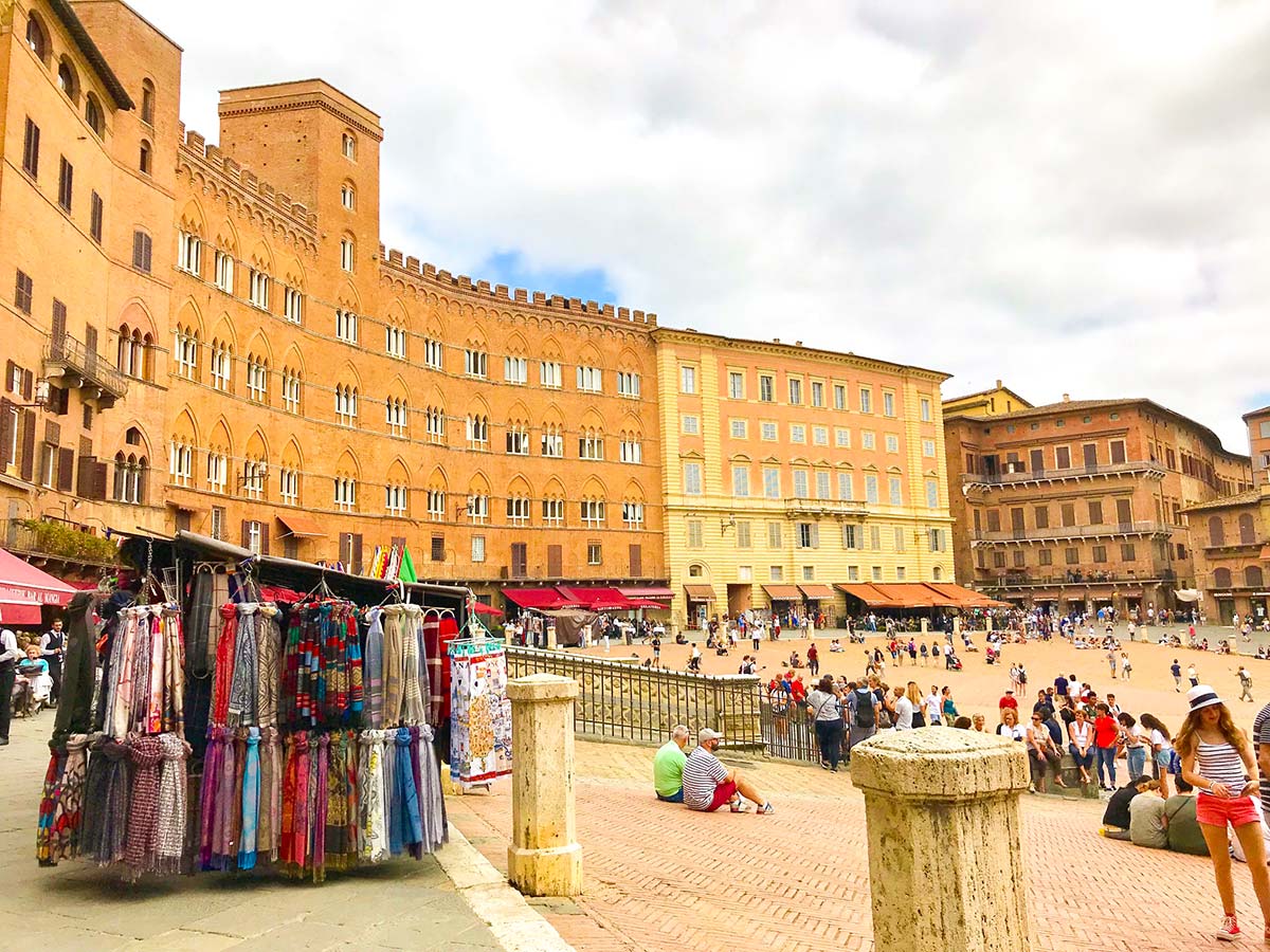 Lounging in Campo Square on Monteriggioni to Piazza del Campo Siena Via Francigena Hike in Tuscany, Italy