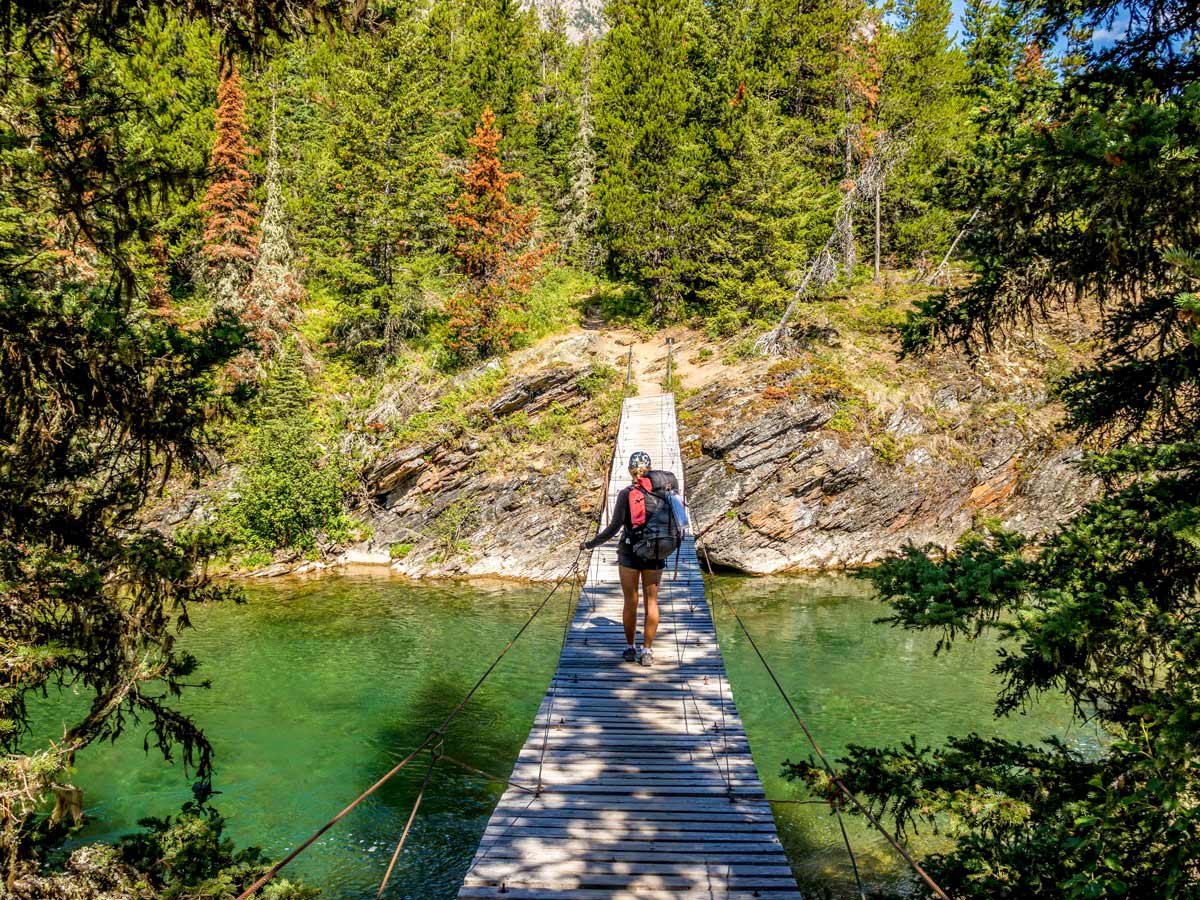 Crossing a suspension bridge on the backpack to Boulder Pass in Glacier National Park