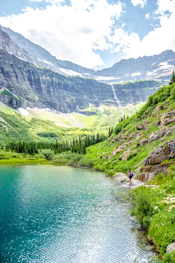 Filling waterbottles in a lake on the trail to Boulder Pass in Glacier National Park