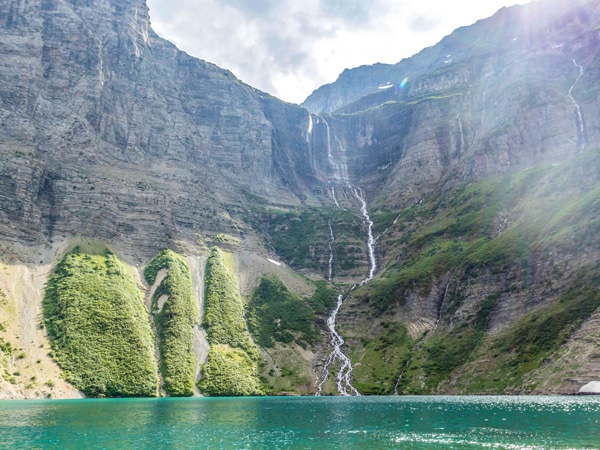 Picturesque lake and waterfalls on Boulder Pass Backpacking Trail in Glacier National Park in Montana