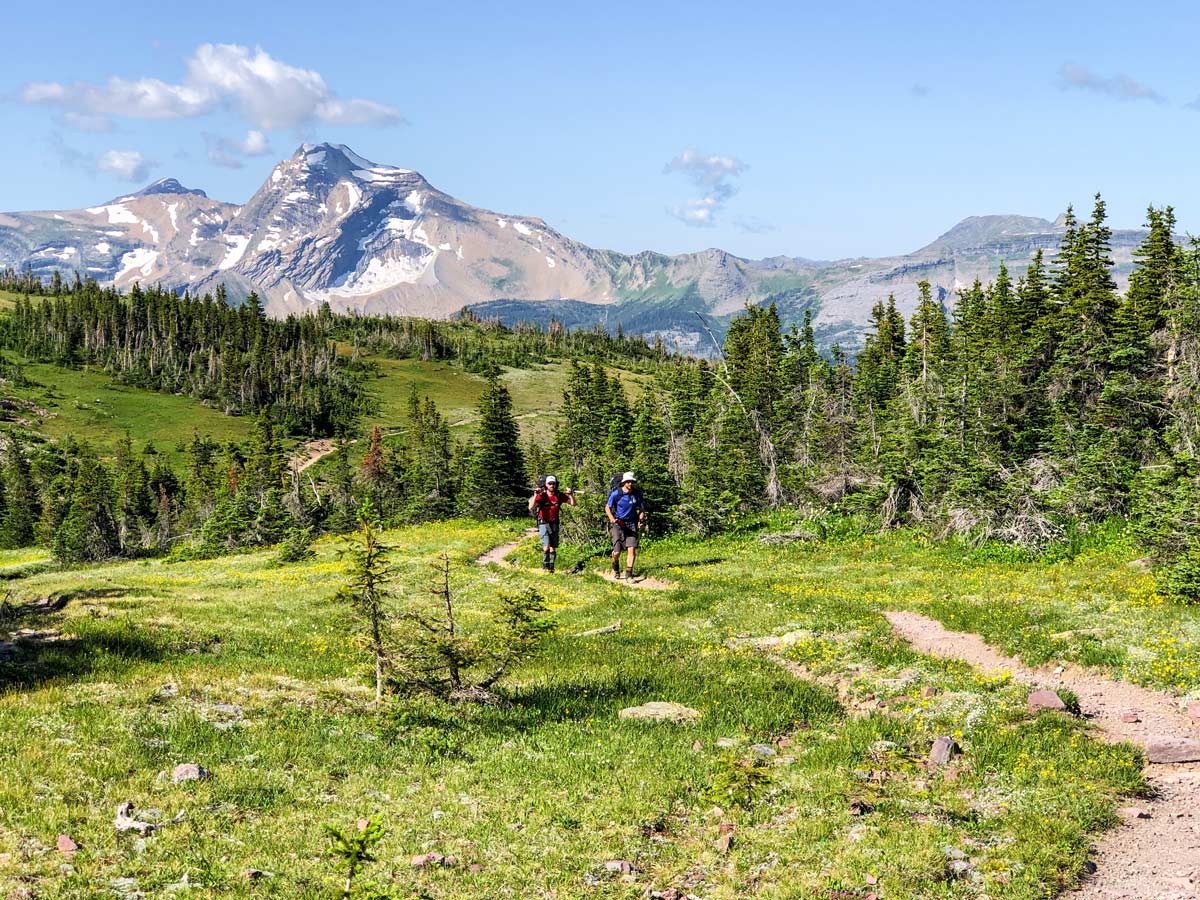 Two backpackers near Swiftcurrent Pass on Highline backpacking trail in Glacier National Park, Montana