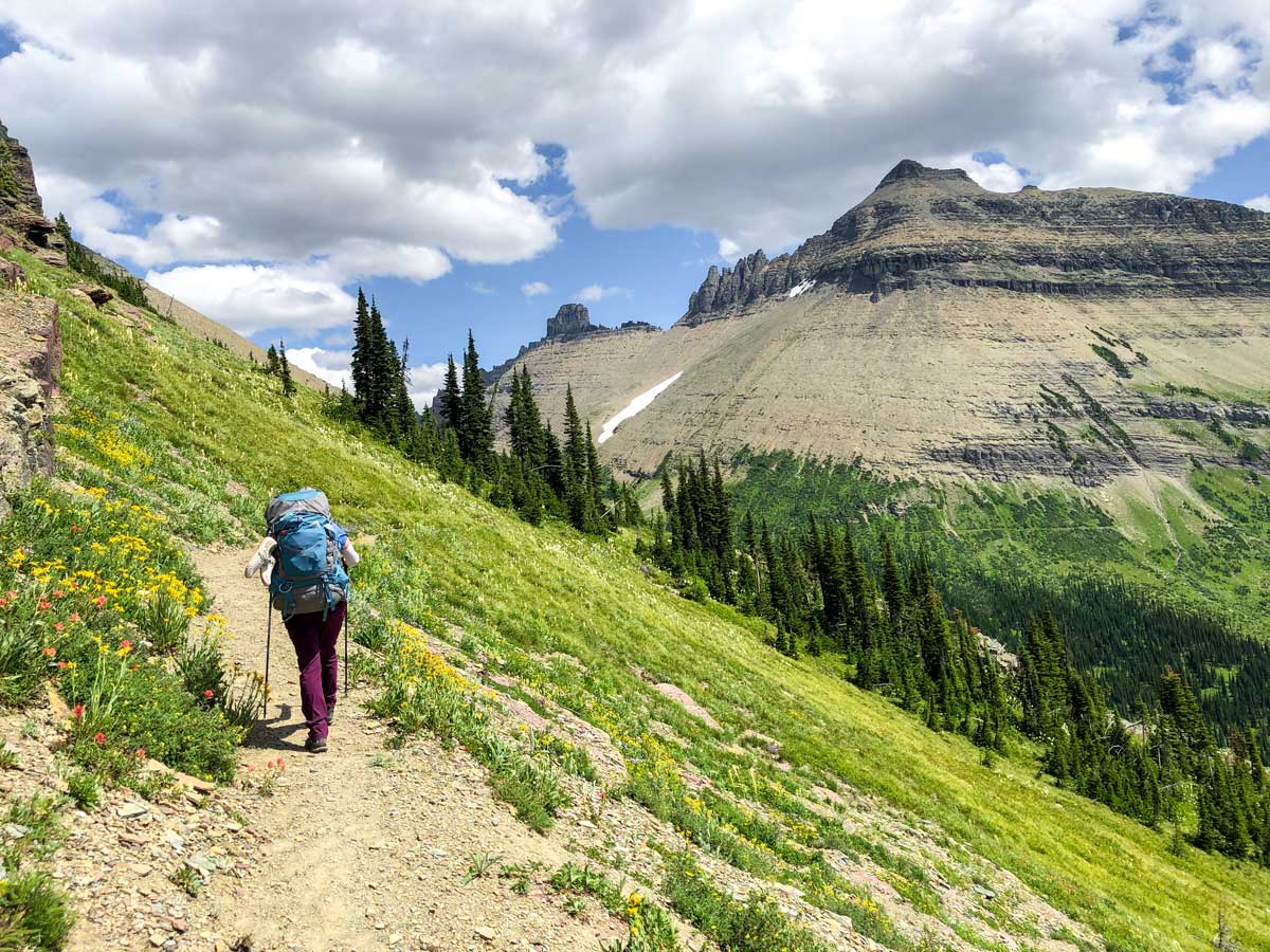 Backpacker with gear on Highline backpacking trail in Glacier National Park, Montana