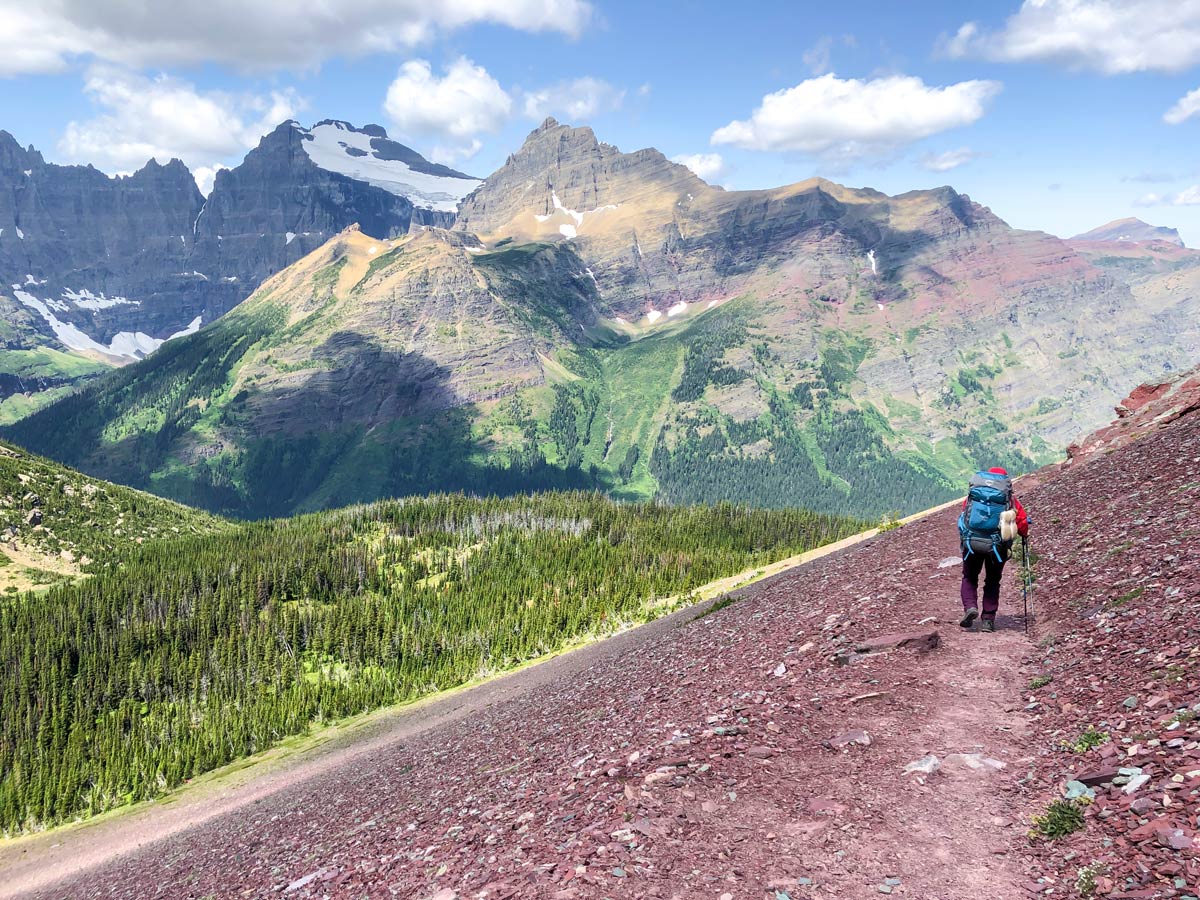 Backpacker surrounded by mountains on North Circle Backpacking Trail in Glacier National Park
