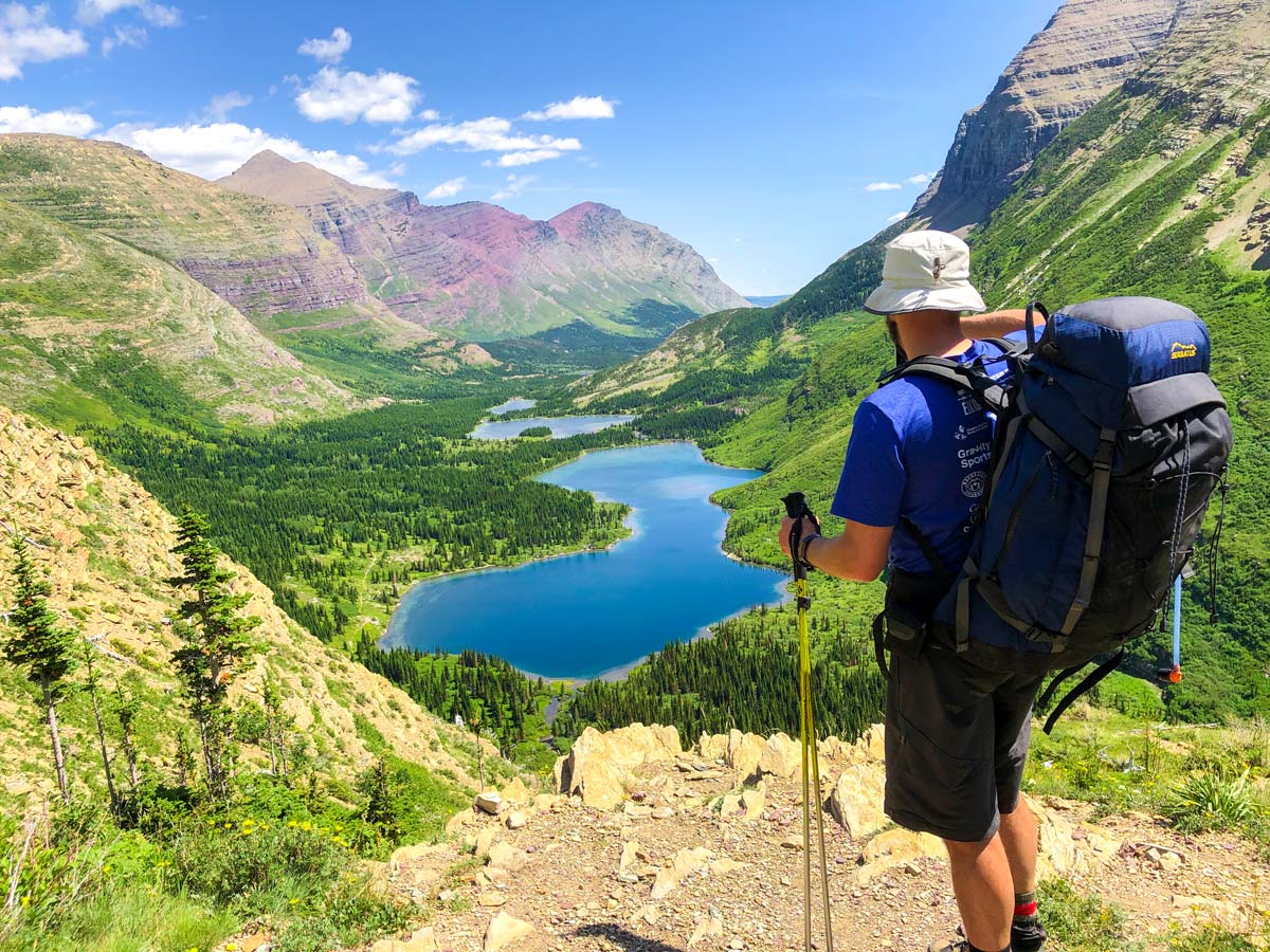 Hiker looking down on the Bullhead lake on North Circle Backpacking Trail in Glacier National Park