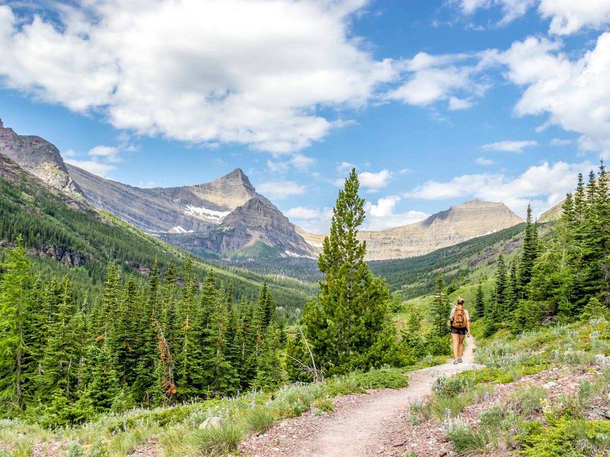 Backpacker surrounded by peaks on Pitamakan Dawson Loop Backpacking Trail in Glacier National Park