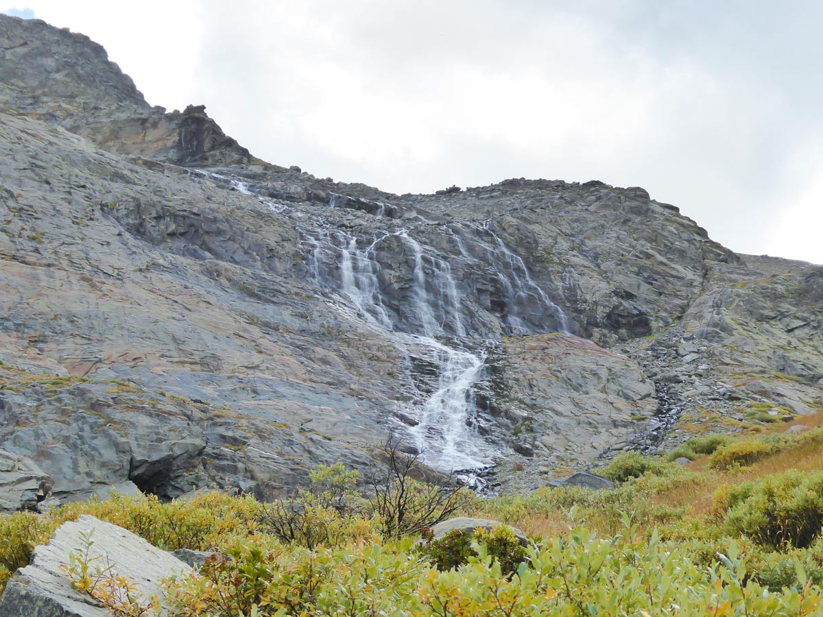 Wide waterfall running from Money Glacier on Alpe Money hike near Aosta