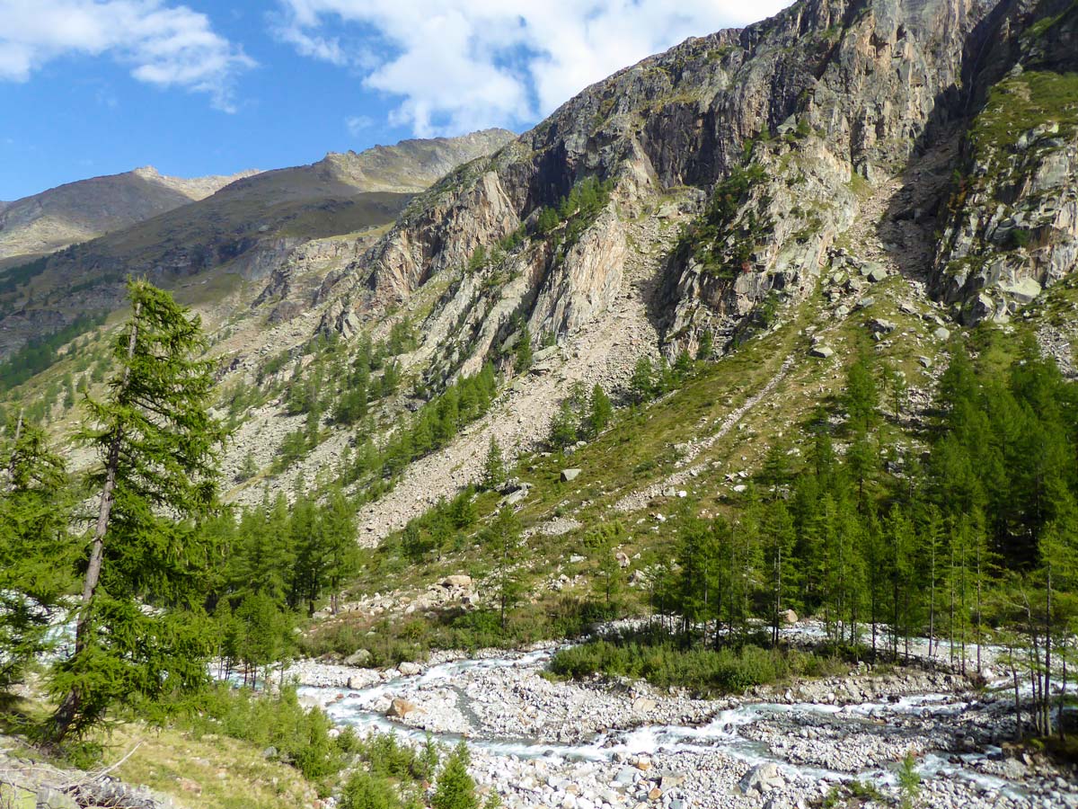 Rocky slopes along the trail on Alpe Money hike in Gran Paradiso National Park, Italy