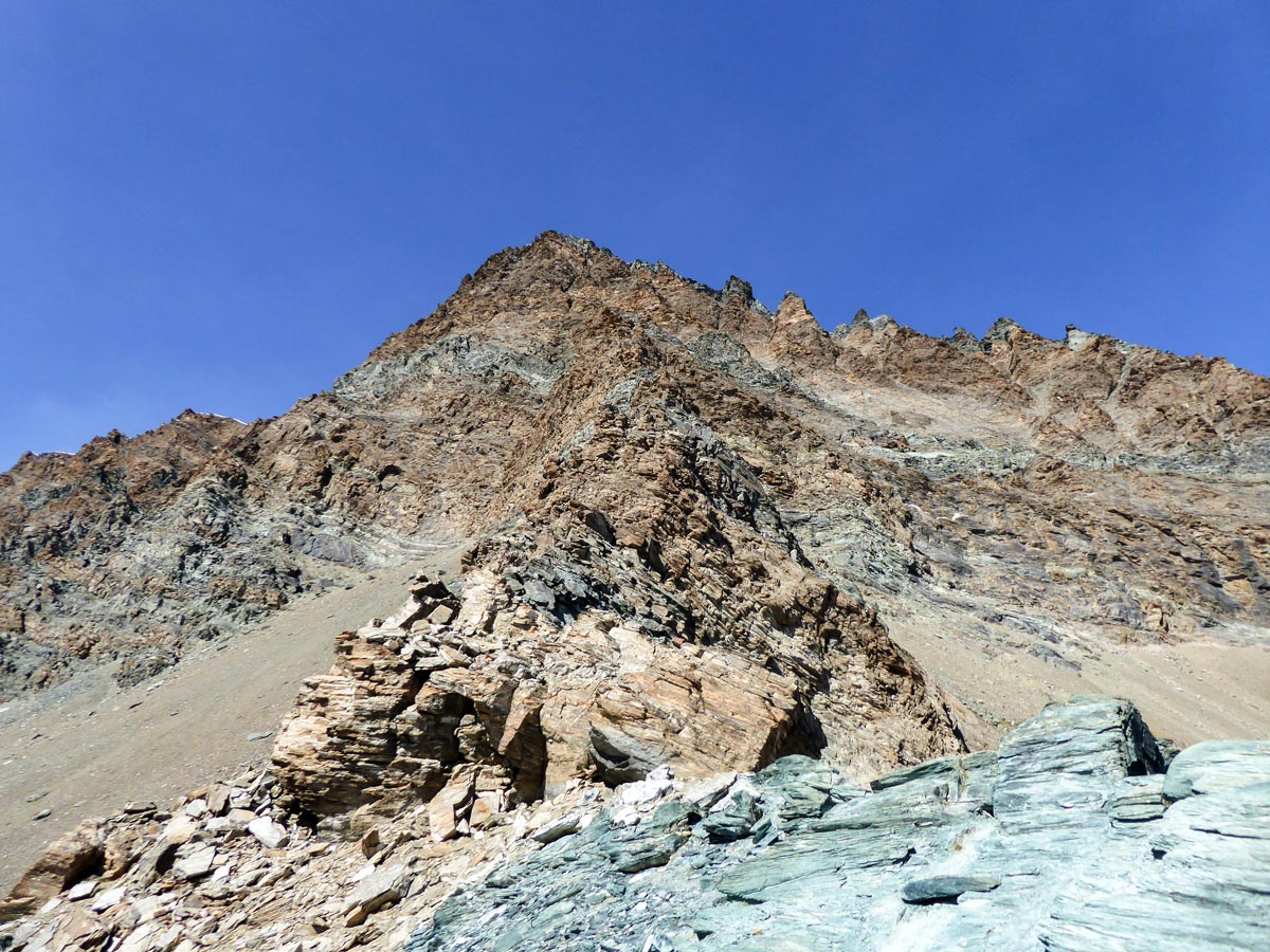 Red rocks of Punta Rossa Della Grivola on Colle della Rossa hike in Gran Paradiso National Park, Italy