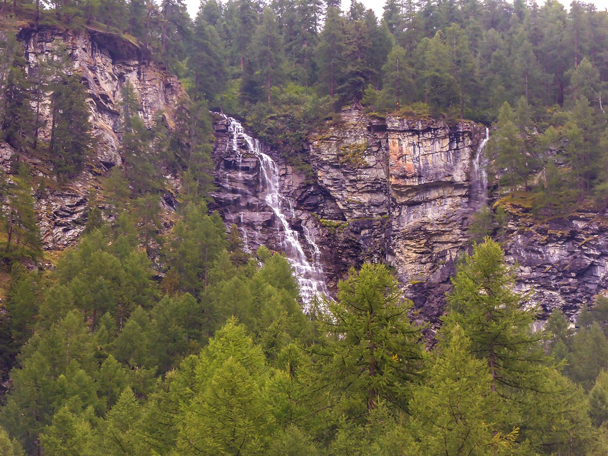 Beautiful waterfall along the trail of Lago Pellaud via the Grand Rû Ring hike near Gran Paradiso National Park, Italy