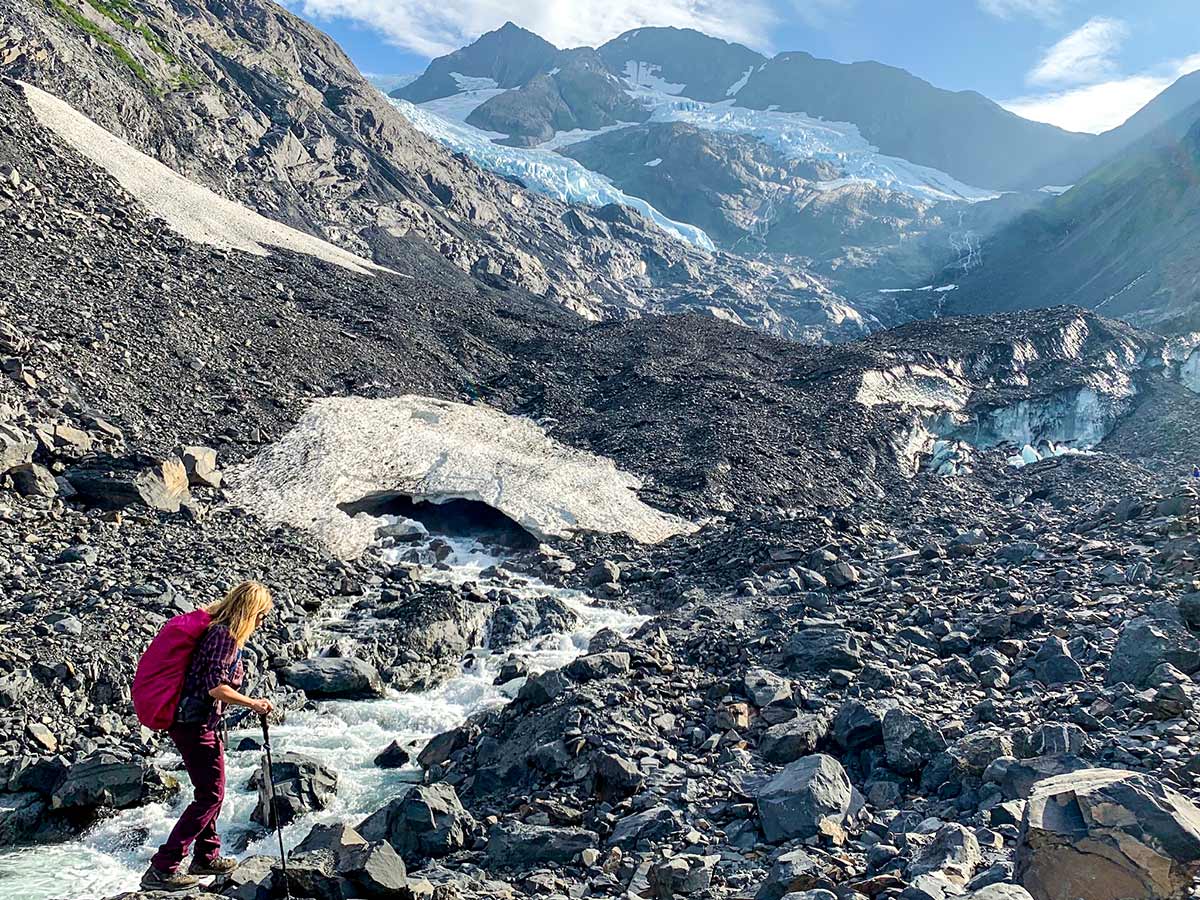 Hiker on a rocky part of Byron Glacier Trail in Kenai Peninsula Alaska