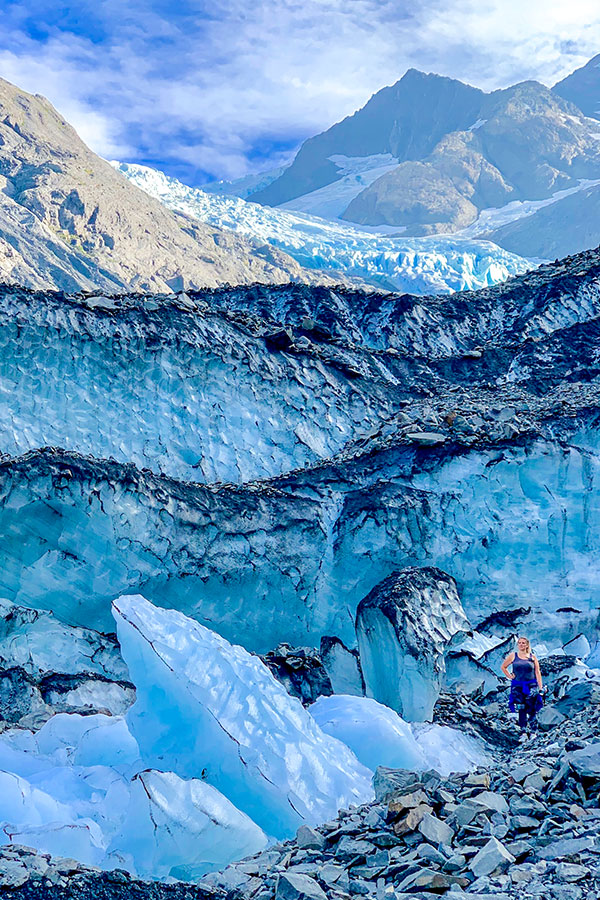 Hiker posing near Byron Glacier on a hike in Kenai Peninsula Alaska