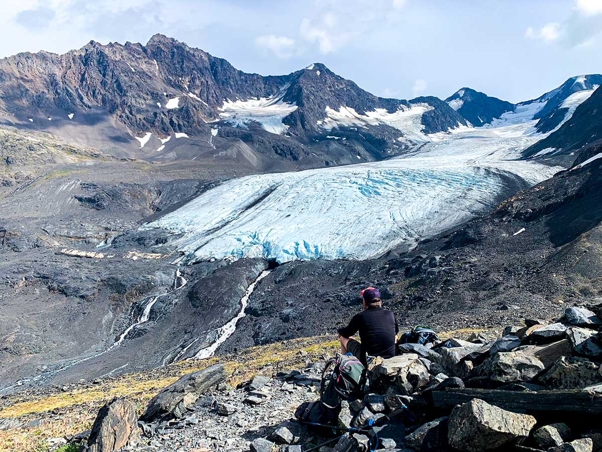 Hiker looking towards Raven Glacier on a Crow Pass Hike in Alaska