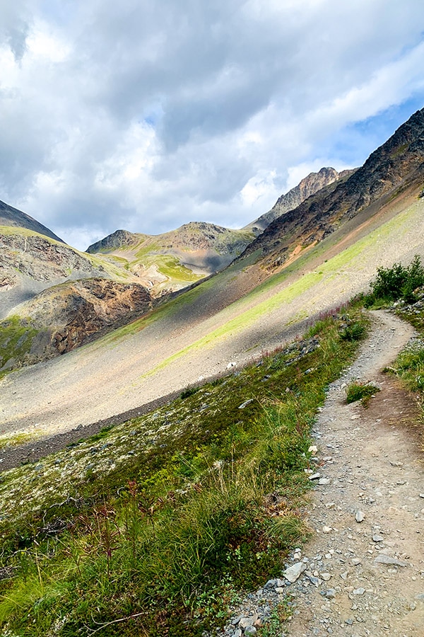 Colorful mountain path to Crow Pass and Raven Glacier overlook in Alaska