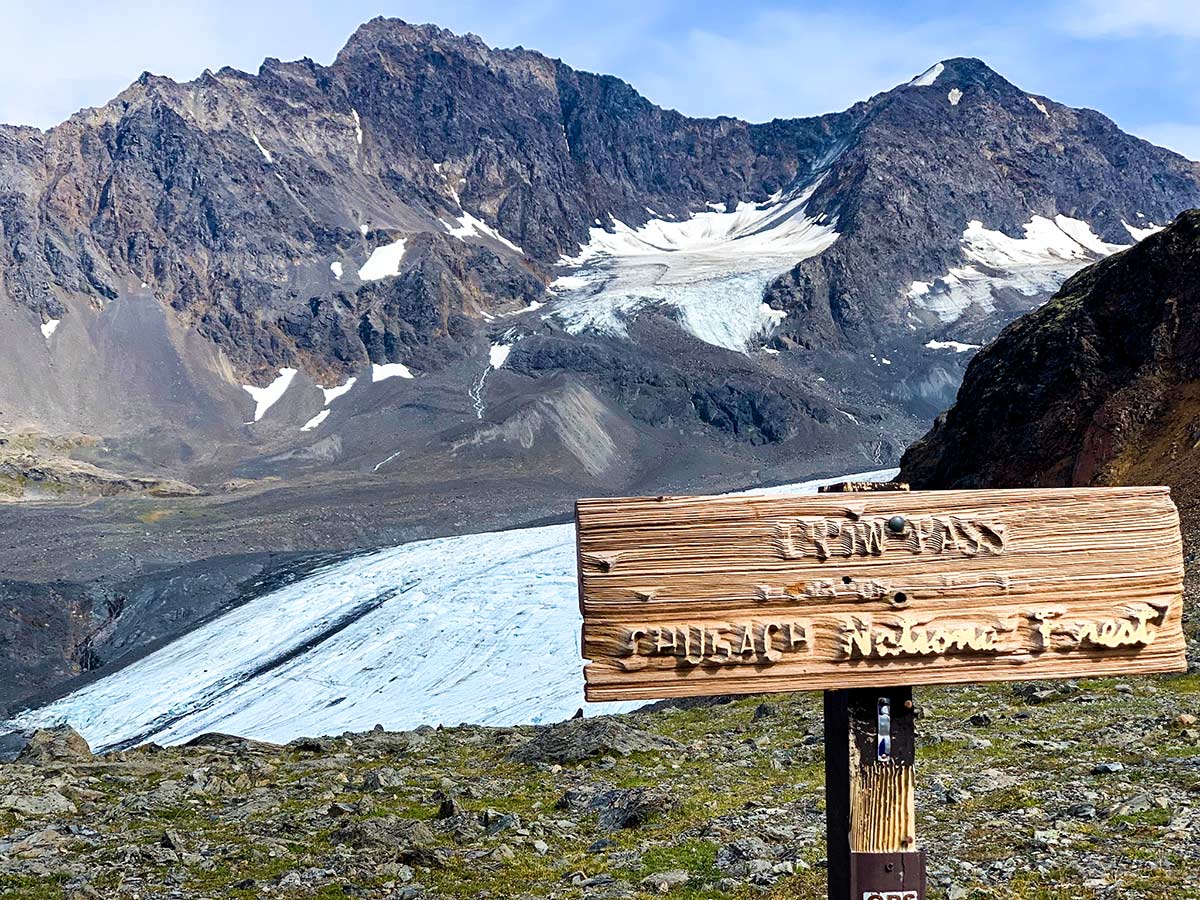 Crow Pass Trail signpost in front of Raven Glacier near Anchorage