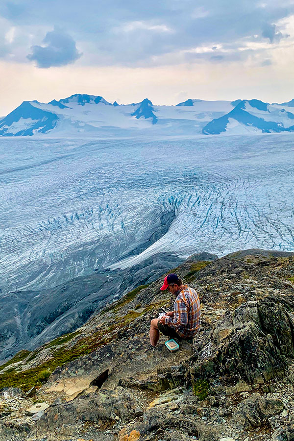 Hiker resting on Harding Icefield Trail near Anchorage Alaska