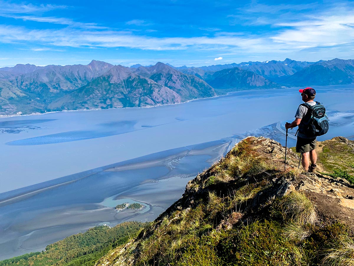 Hiker on an overlook to Turnagain Arm on Hope Point Trail in Kenai Mountains