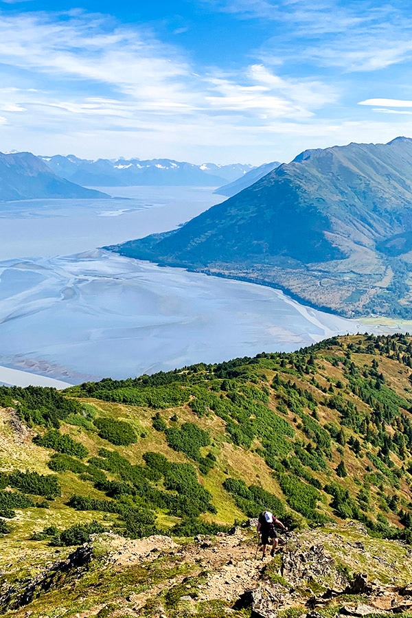 Hiker on a rocky part of Hope Point Trail in Kenai Peninsula Alaska