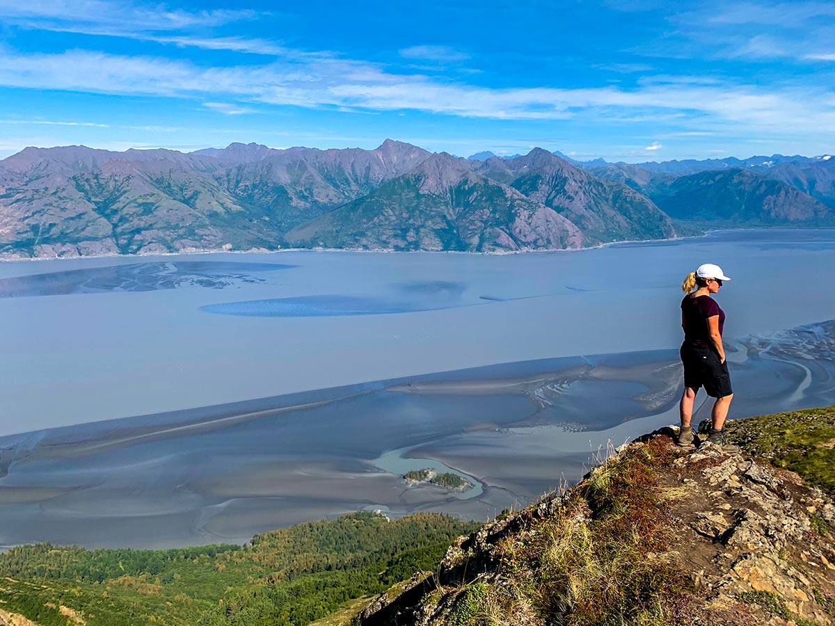 Hiker posing on overlook to Turnagain Arm on Hope Point Trail in Alaska