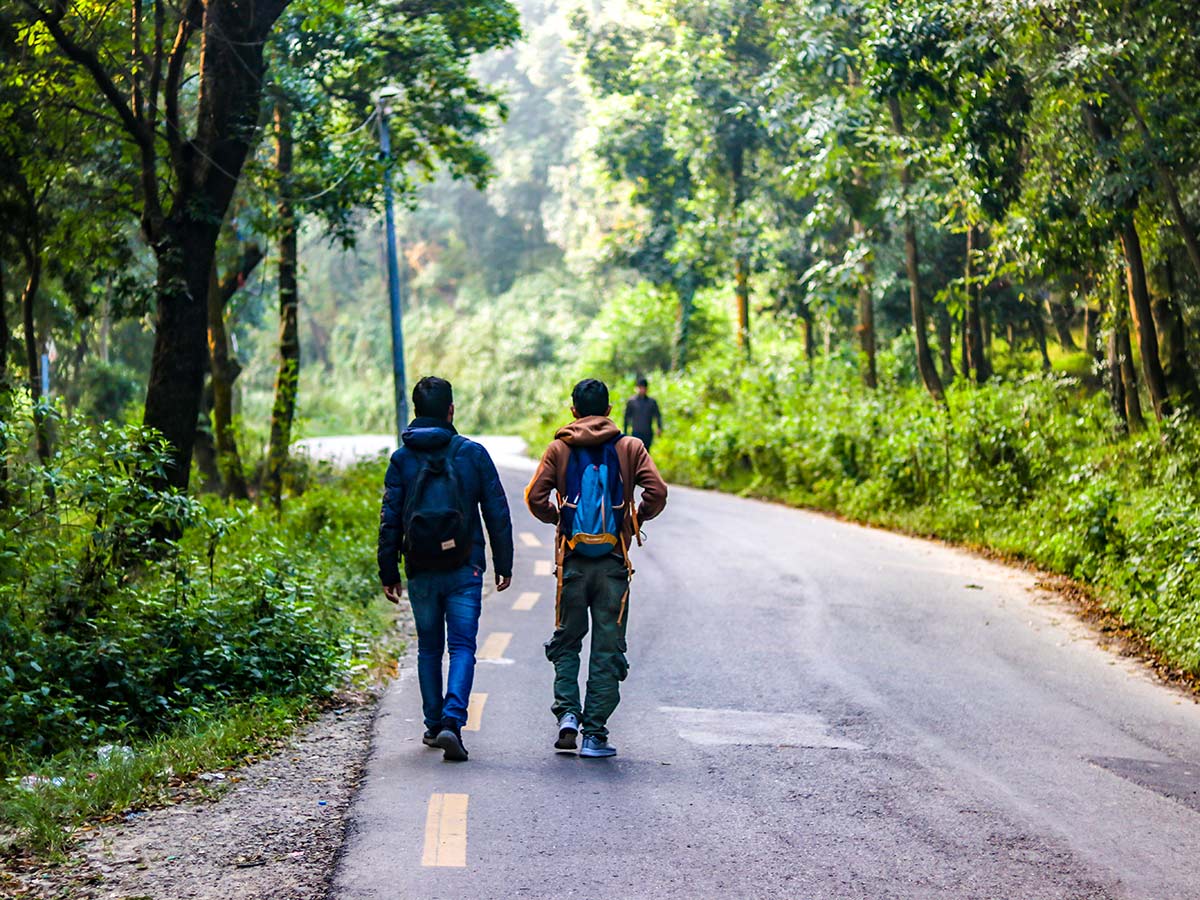 Hikers walking the black topped road after Doleshwor Mahadev Bus Stop