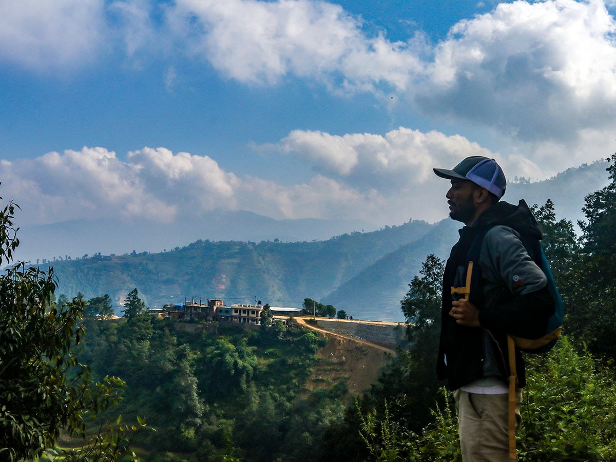 A hiker overlooking the view of the valley from Ghyampe Danda