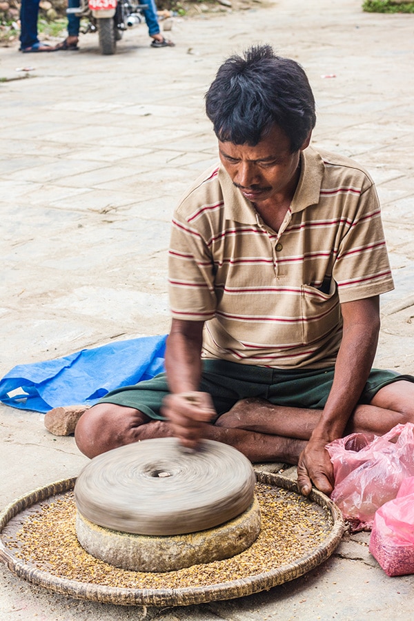 A man seen grinding the local herbs in Kirtipur