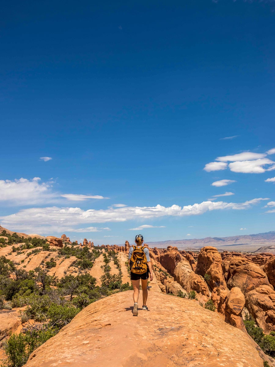 Woman hiking along Devils Garden loop in Arches NP