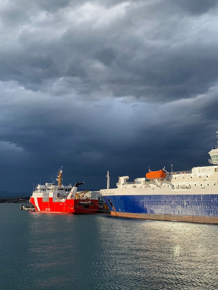 Storm clouds approaching ships at Ogden Point along one of the best hiking trails near Victoria