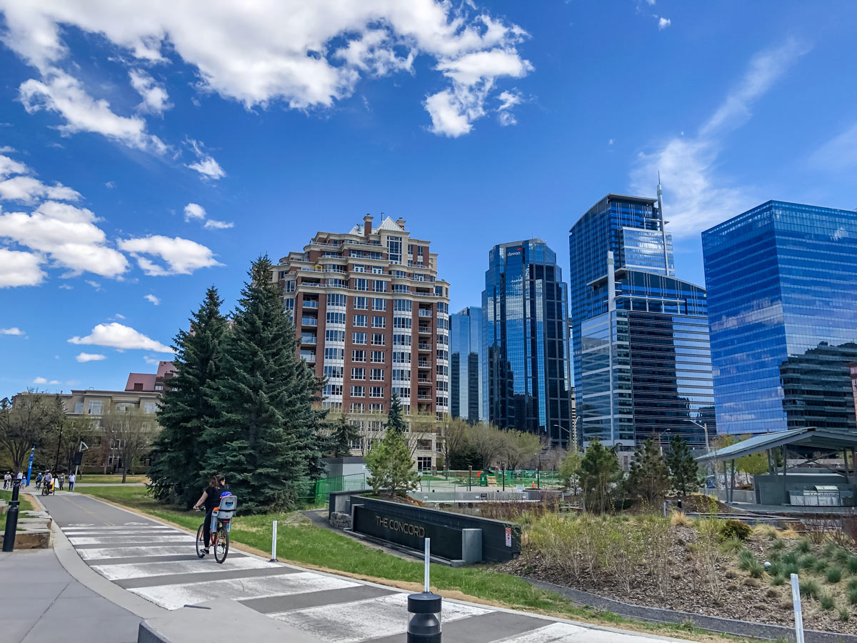 Pedestrians strolling down walking path around Downtown Calgary