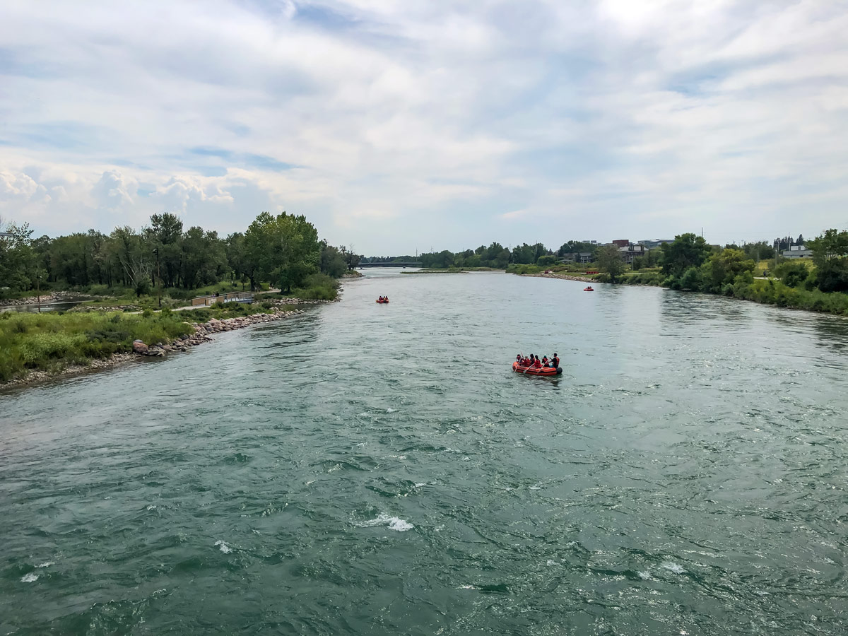 Floating down the Bow River viewed from bridge along city walk in Calgary Alberta
