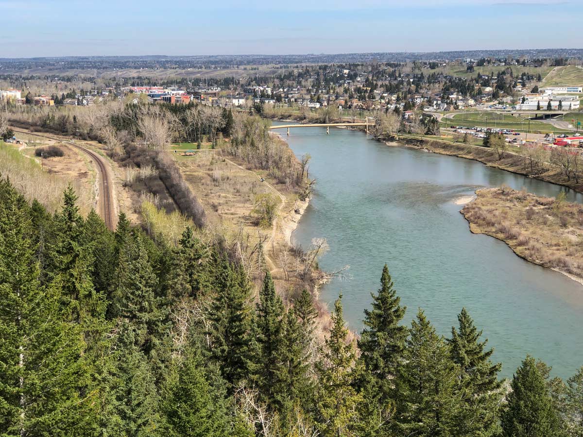 Beautiful views of river bridge and city seen from Douglas Fir Trail walking in Calgary Alberta