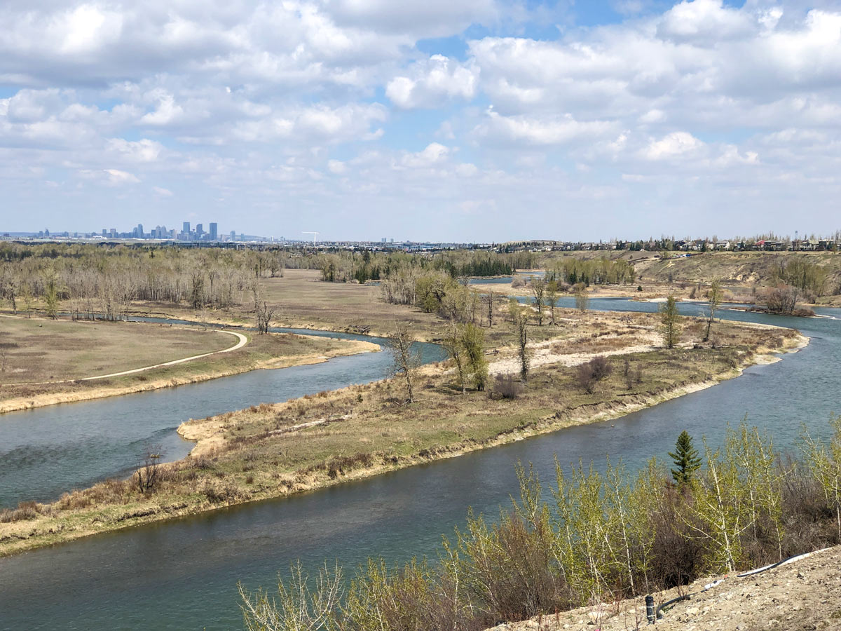 Meandering river and Calgary city skyline viewed from walking trails in Cranston Ridge area Calgary Alberta