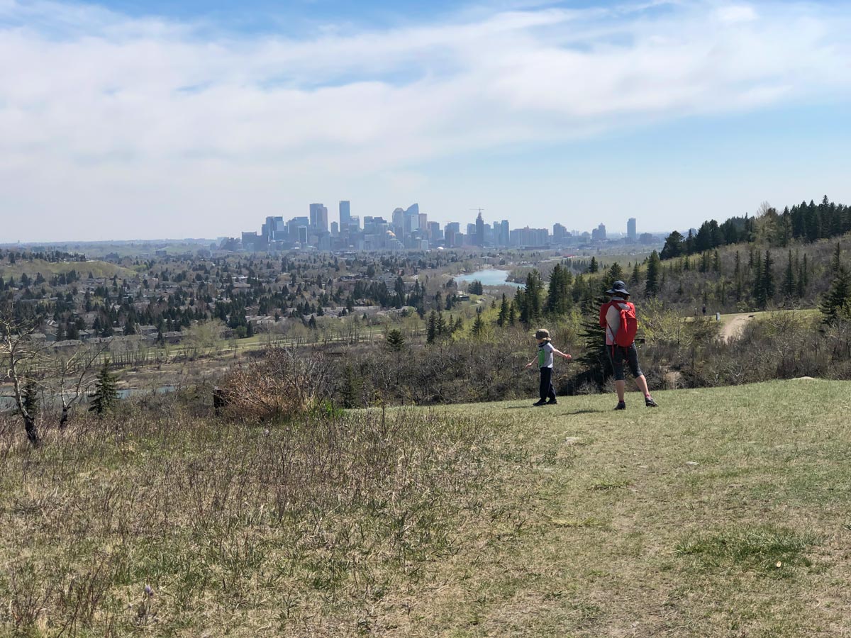 Family walking in Calgary Alberta along Douglas Fir walking trail