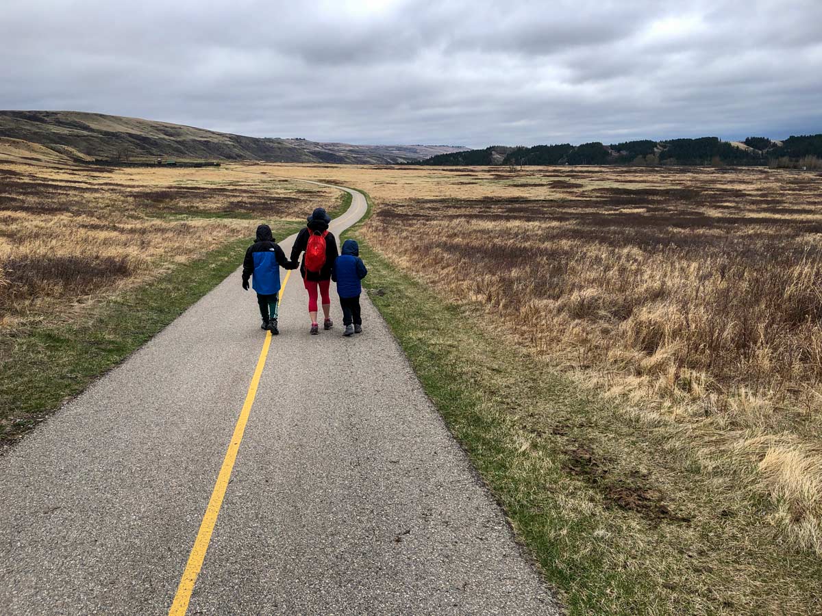 Family walking along Glenbow Ranche walking paths near Calgary Alberta