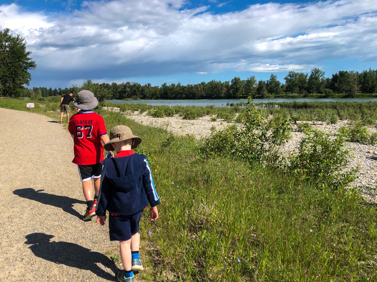 Kids play along Inglewood Bird Sanctuary walking path in Calgary Alberta