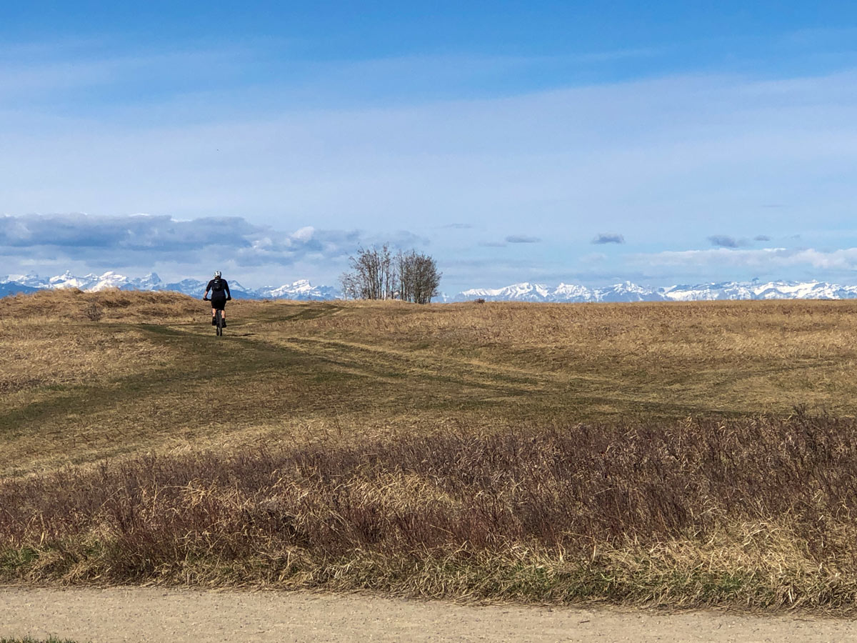 Biker in Nosehill Park along pathways in Calgary Alberta