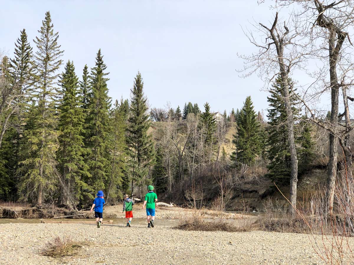 Kids playing along the shores of West Fish Creek in Calgary Alberta