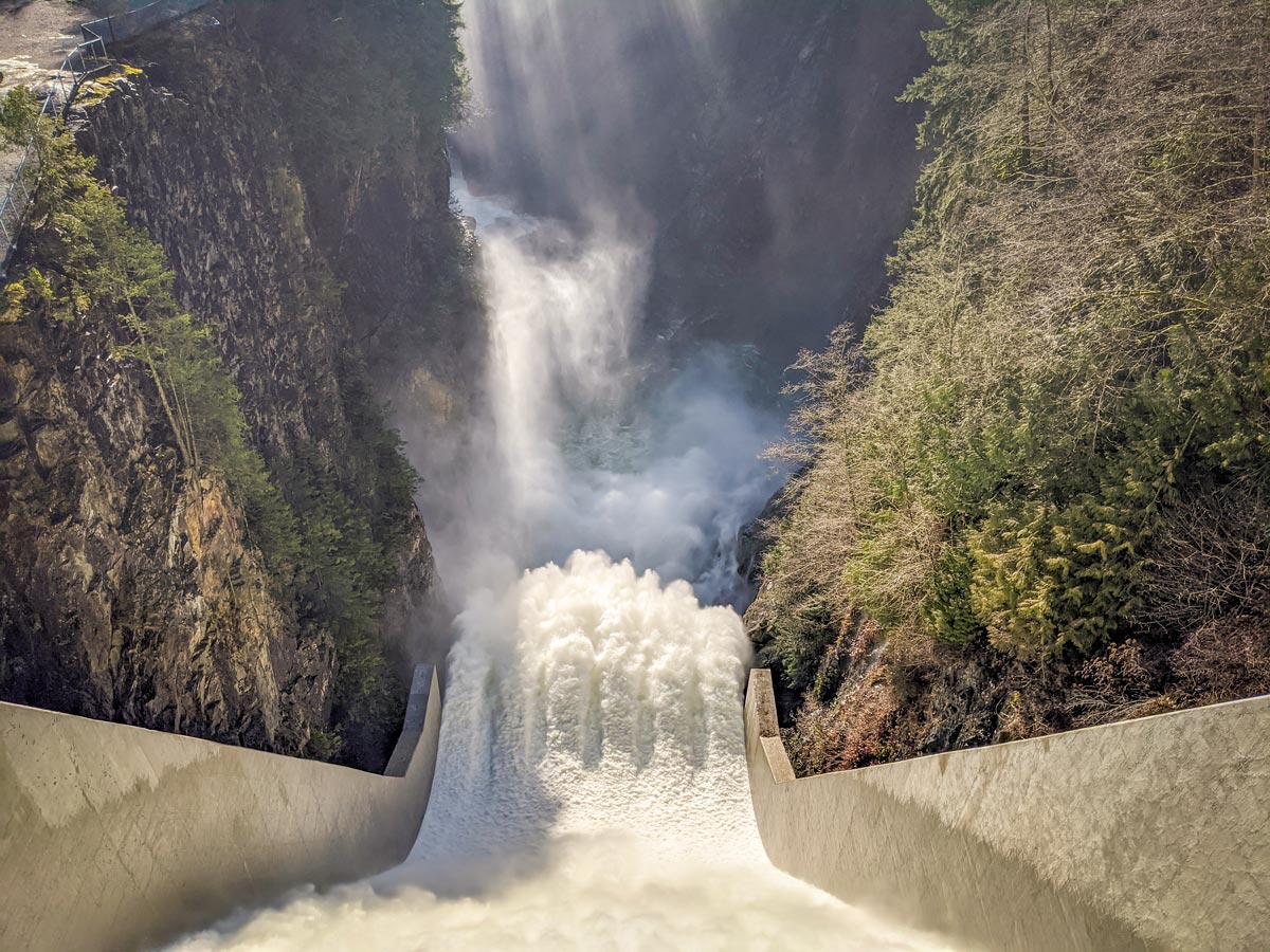 Rushing Capilano river waters down channel in North Shore region Canada West Coast